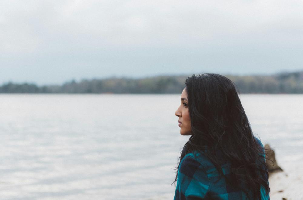 young woman looking out over the ocean 