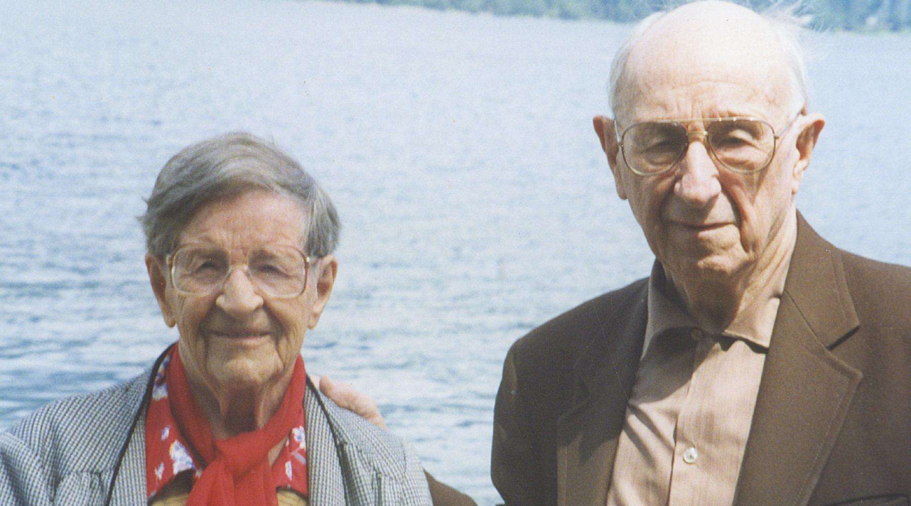 Portrait of Owen and Elsie Williams, standing together outdoors near a lake