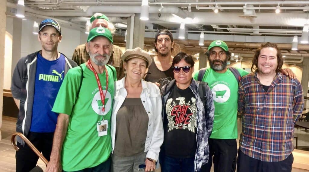 Group of people standing together indoors and smiling