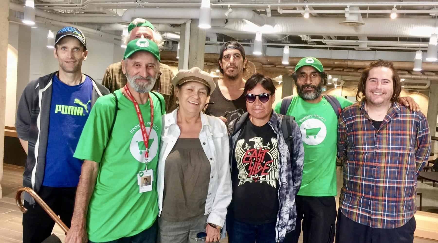 Group of people standing together indoors and smiling