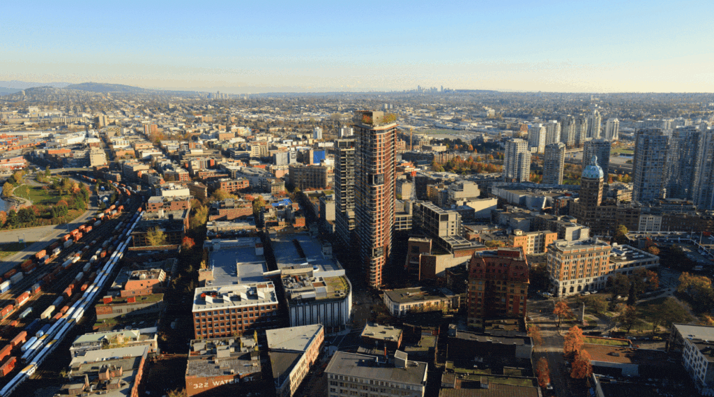 Aerial view of a dense urban neighbourhood with high-rise buildings and rail lines