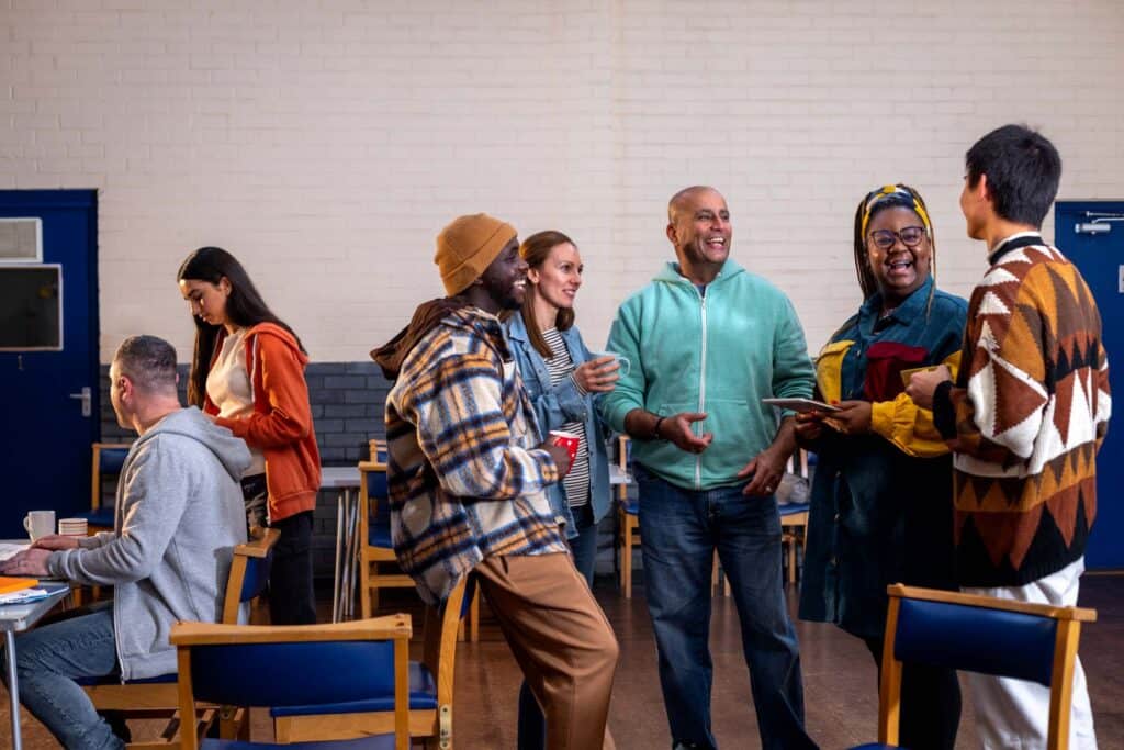 Diverse group of people talking and socializing together in a community meeting space